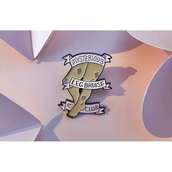 MYSTERIOUS LEG BRUISE CLUB Enamel Lapel Backpack Pin NEW - Picture 1 of 3